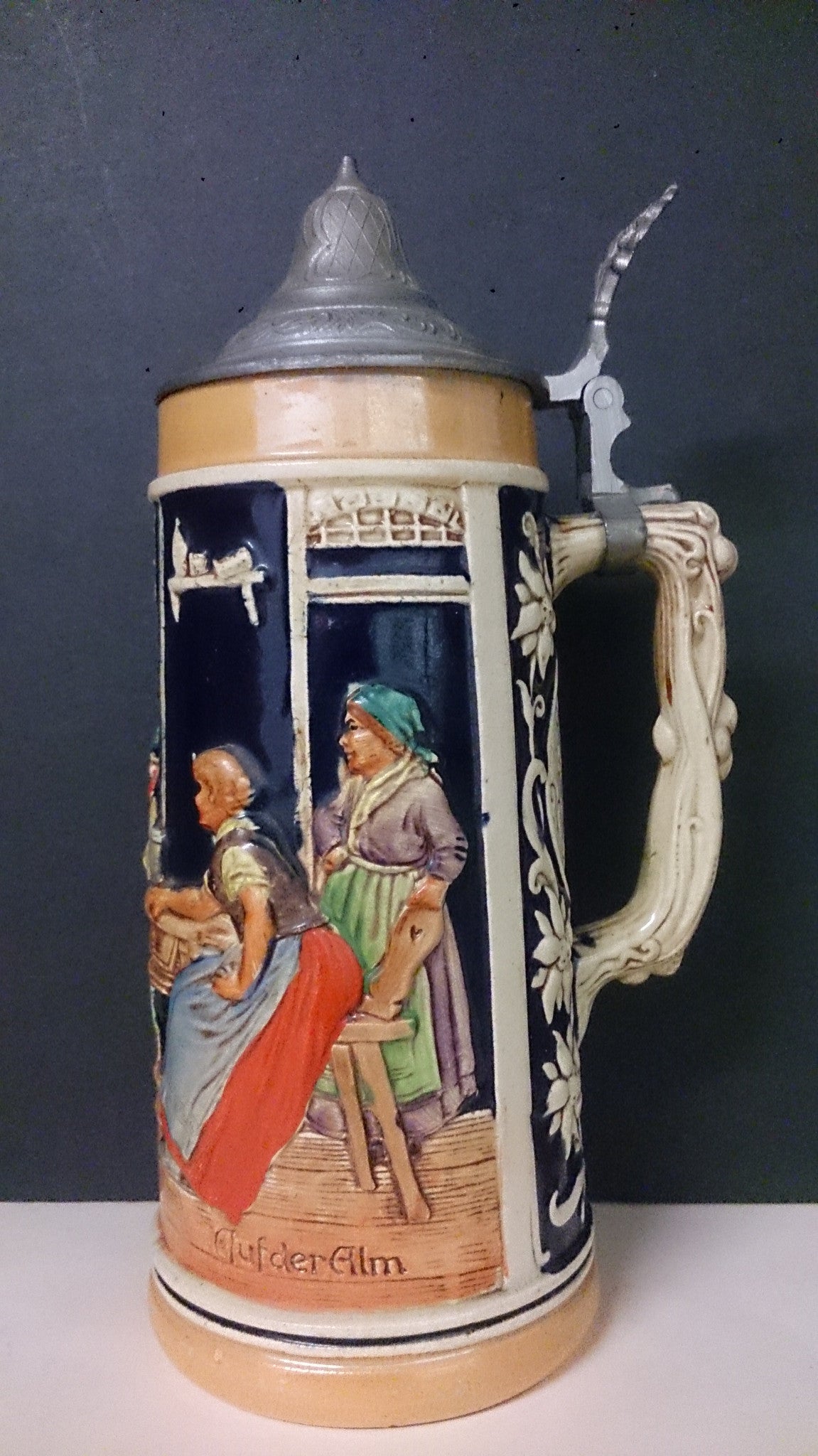 Pilsner Urquell large beer tankard stein. Various scenes with people in period dress newest drinking beer.