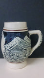 Ceramic Beer Stein, No Lid, Winter Scene, Two Log Cabins and Mountains - Roadshow Collectibles